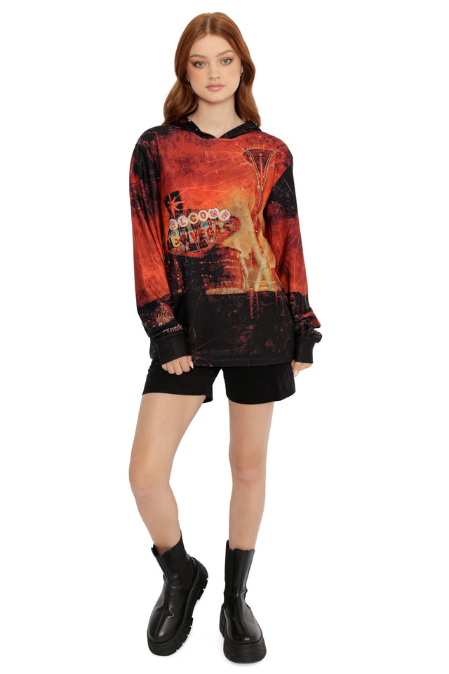 Model wearing Fallout x BlackMilk Enjoy Your Stay Hoodie Sweater featuring New Vegas sign print in red and black tones.