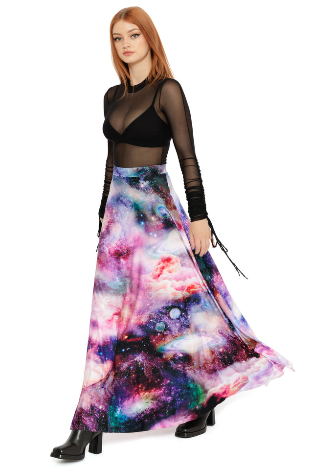 Black mesh long sleeve top styled with a high-waisted cosmic galaxy maxi skirt featuring nebula and star details